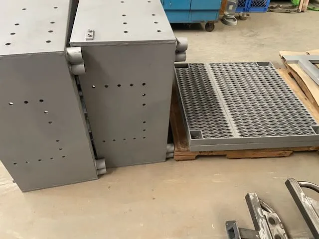 Metal panels and mesh sections in workshop during prep stage