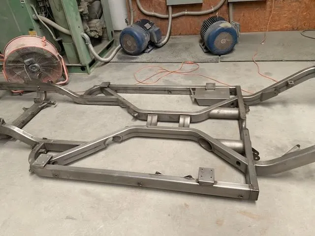 Bare metal frame section with welded joints before treatment
